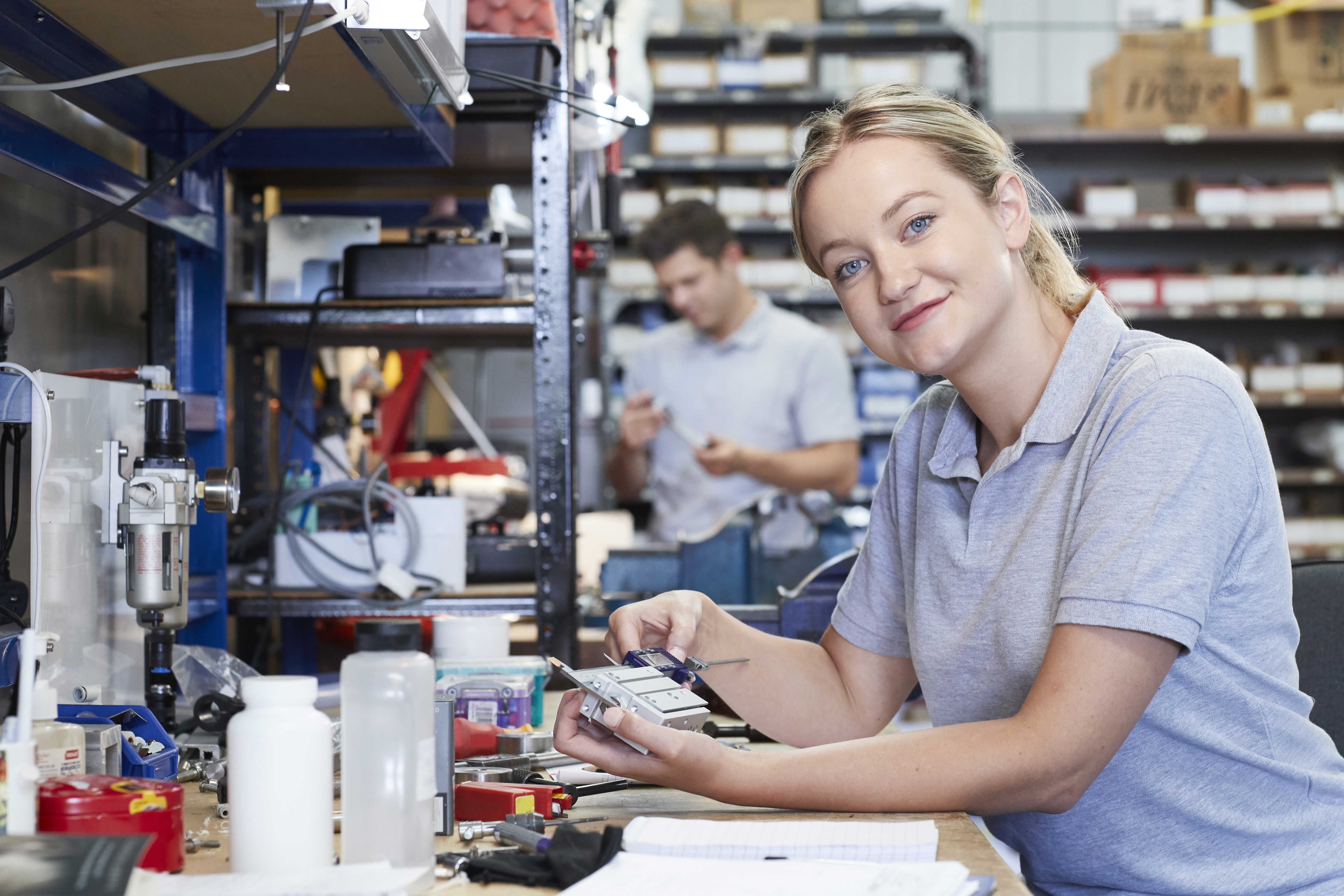 Kvinde står ved værkstøjsbord