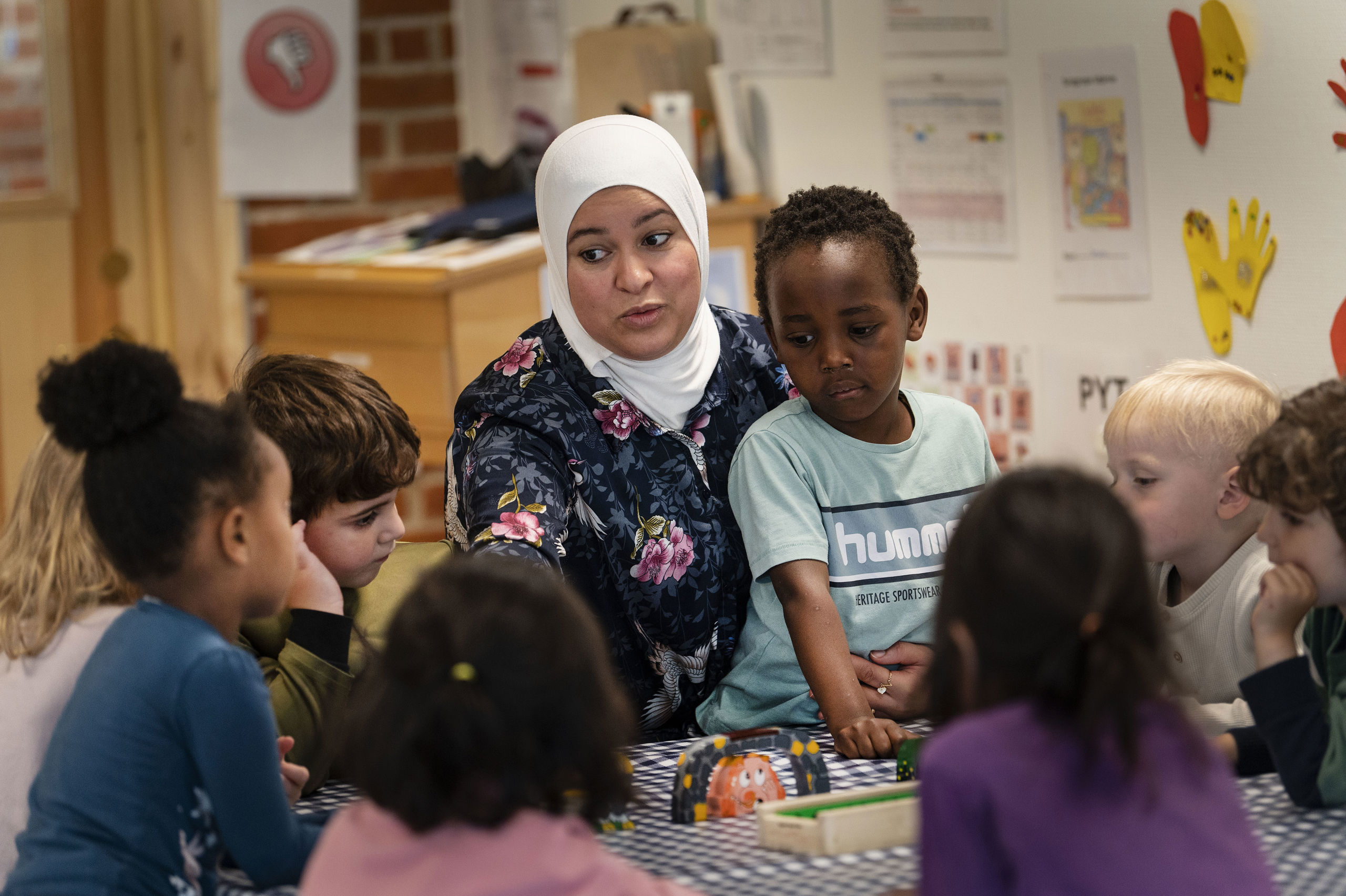 Pædagog sidder med en gruppe børn